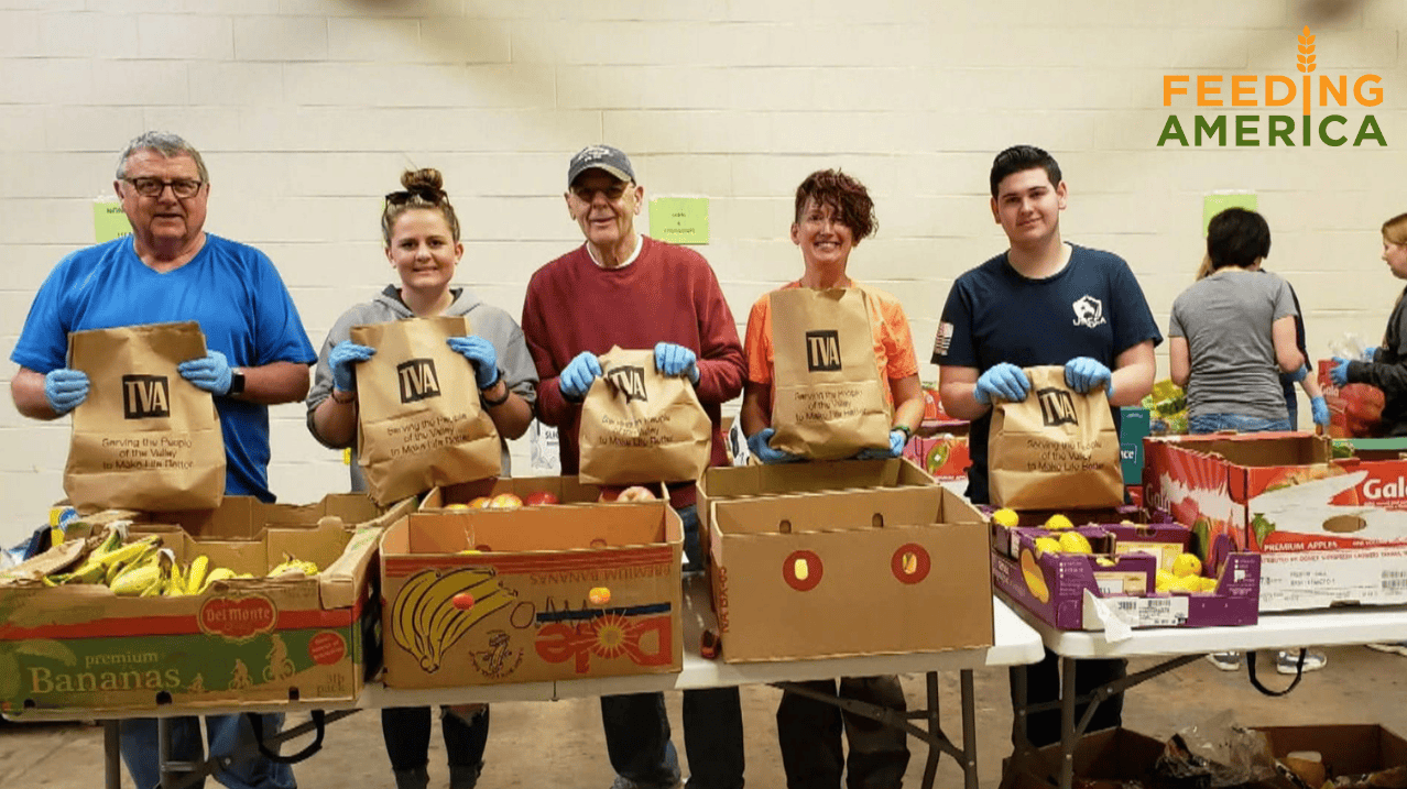 people standing with boxes of food infront of them